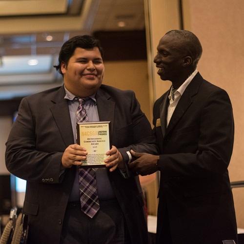 Student, Michael, accepting award at ceremony
