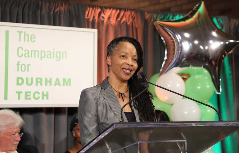 Lois Deloatch speaks at a podium
