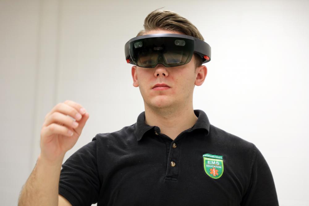 white male student using vr glasses 