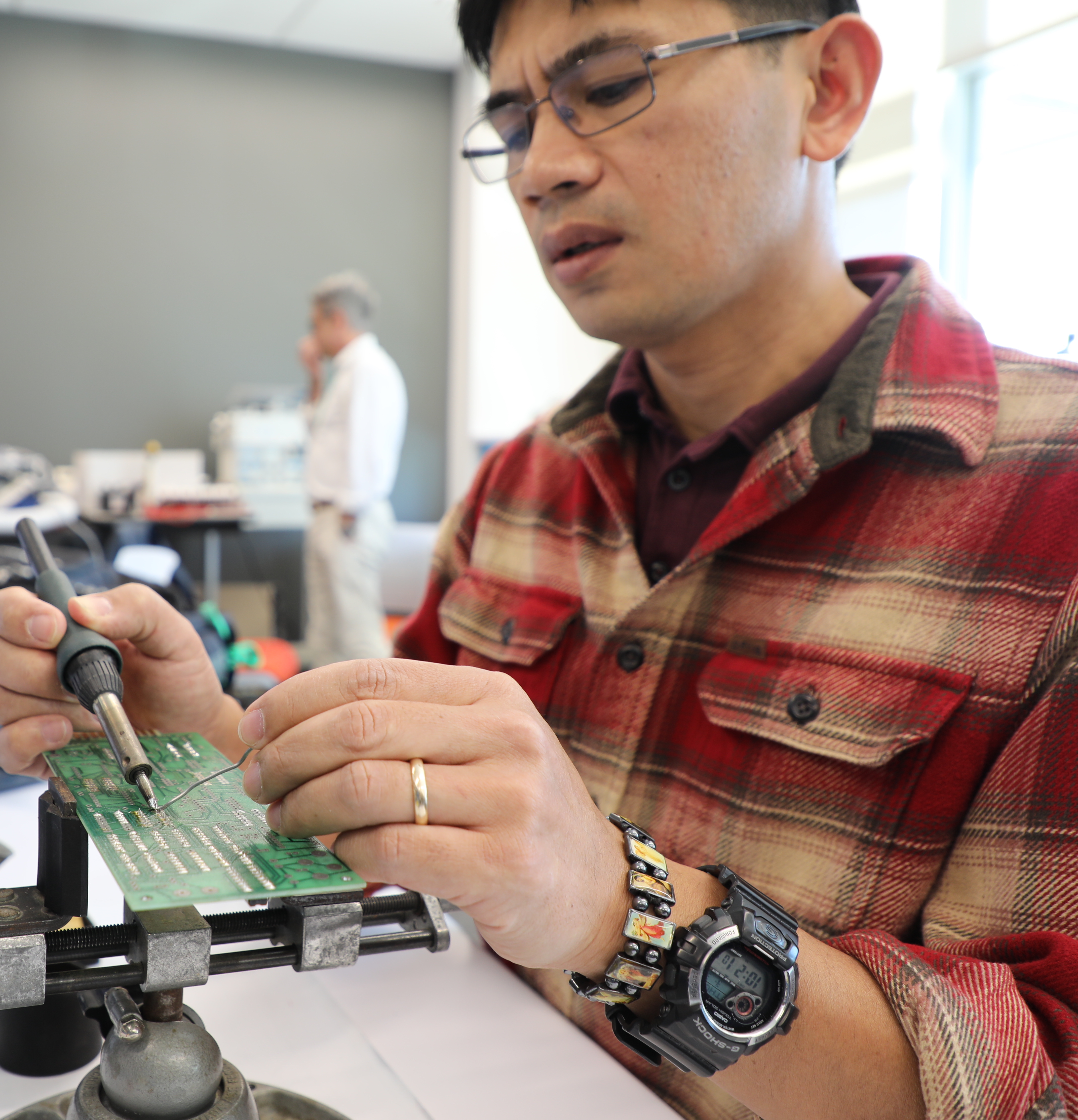 student holding on electrical board