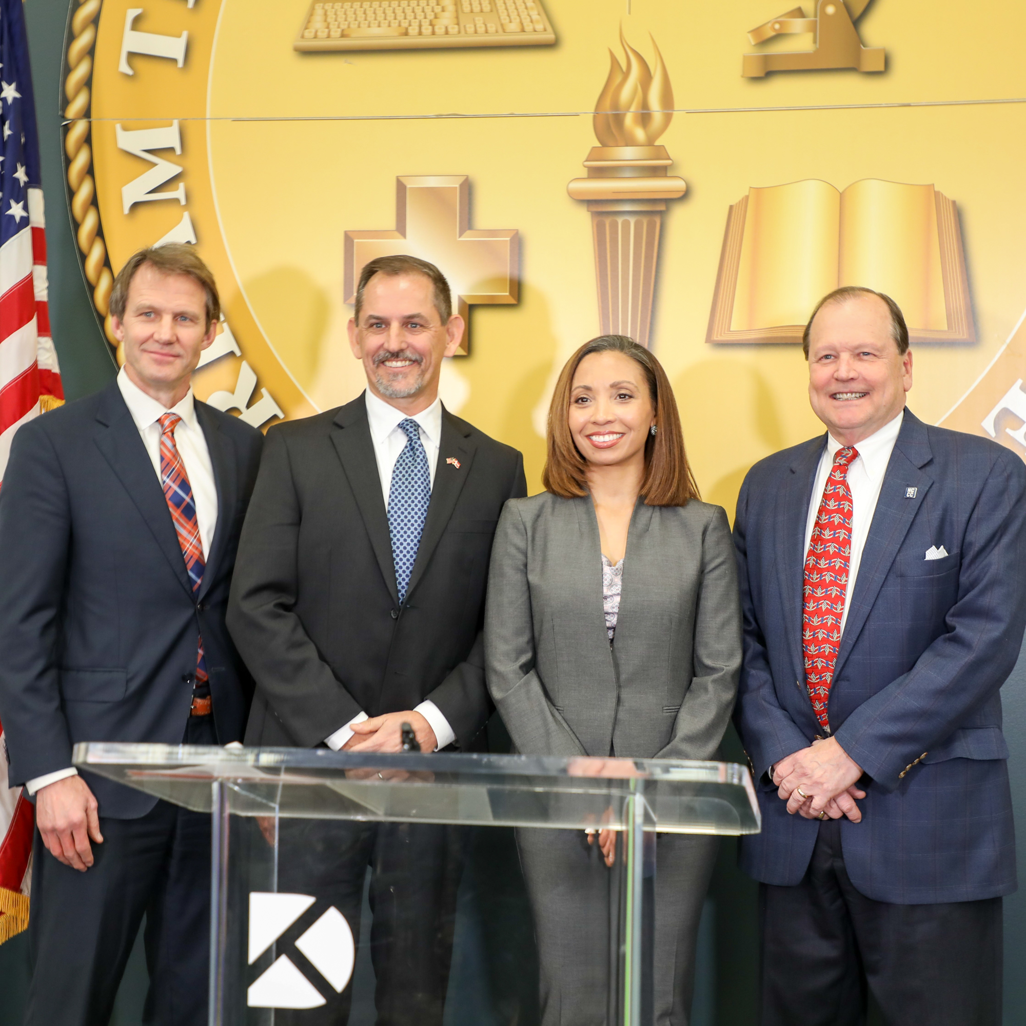 four people smiling for camera