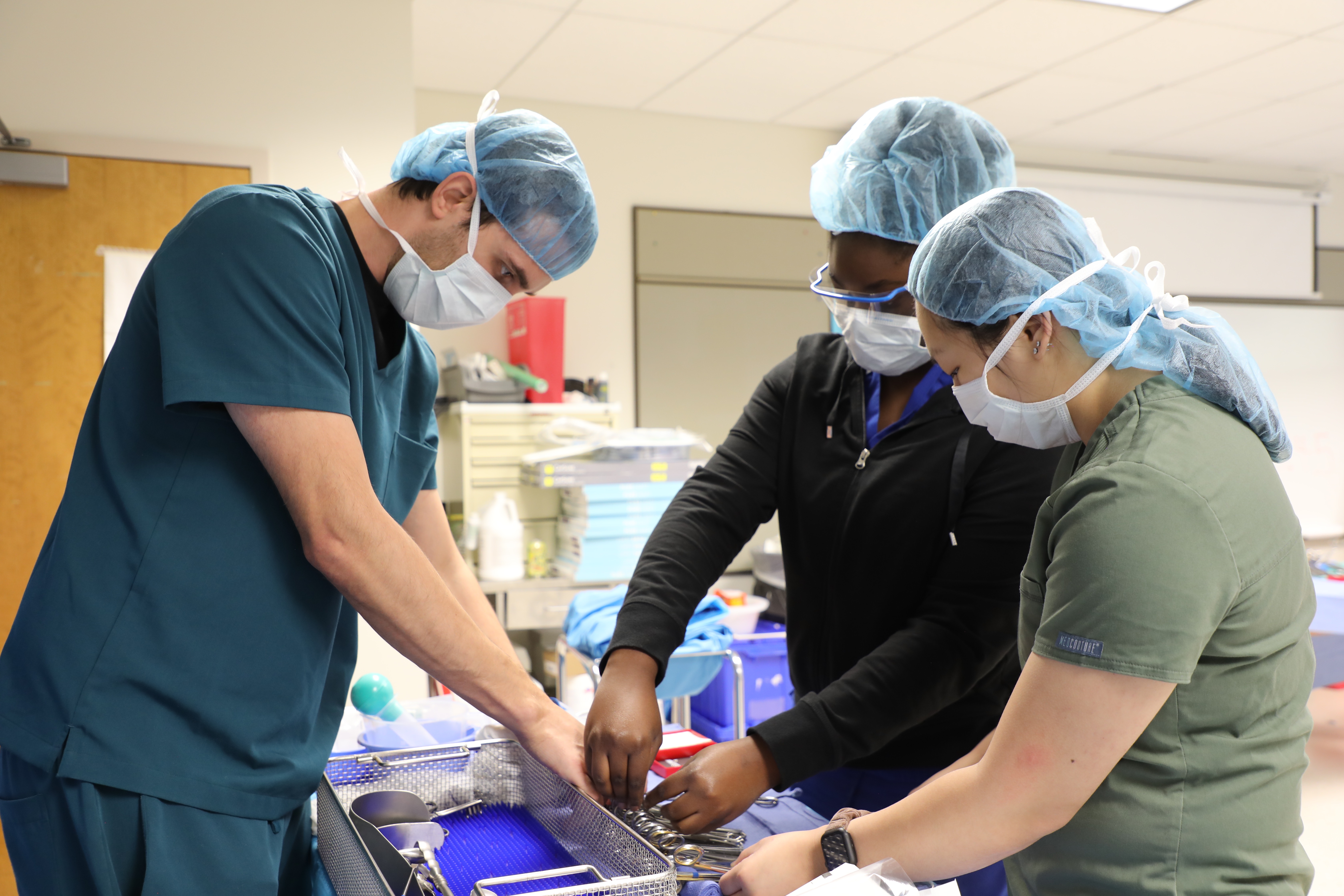 Students practicing the use of medical tools