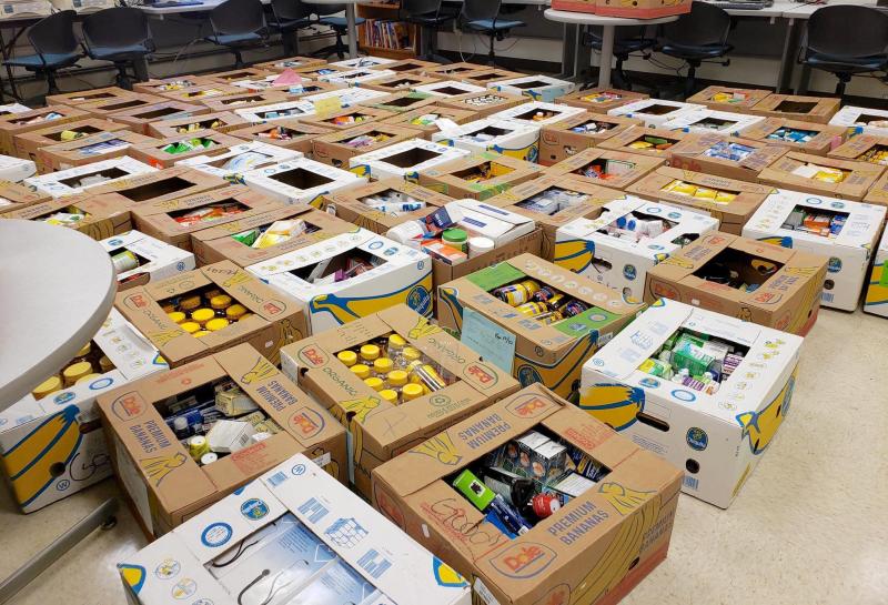room full of boxes with donations on the ground