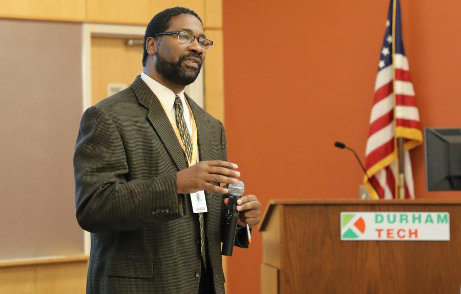 man standing holding. microphone