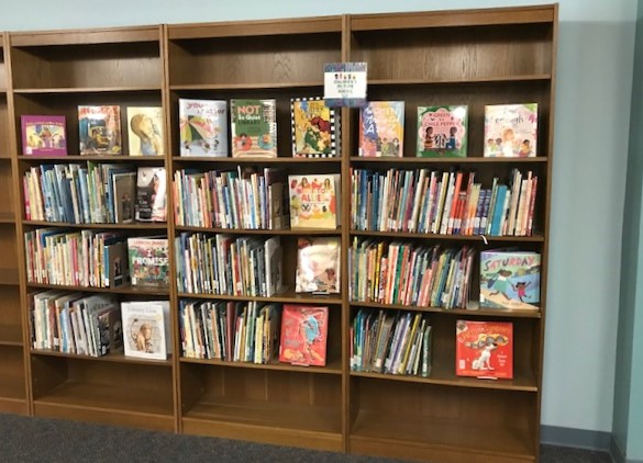 three shelves full of children's books at Main Campus (downstairs by the Q section of the stacks)