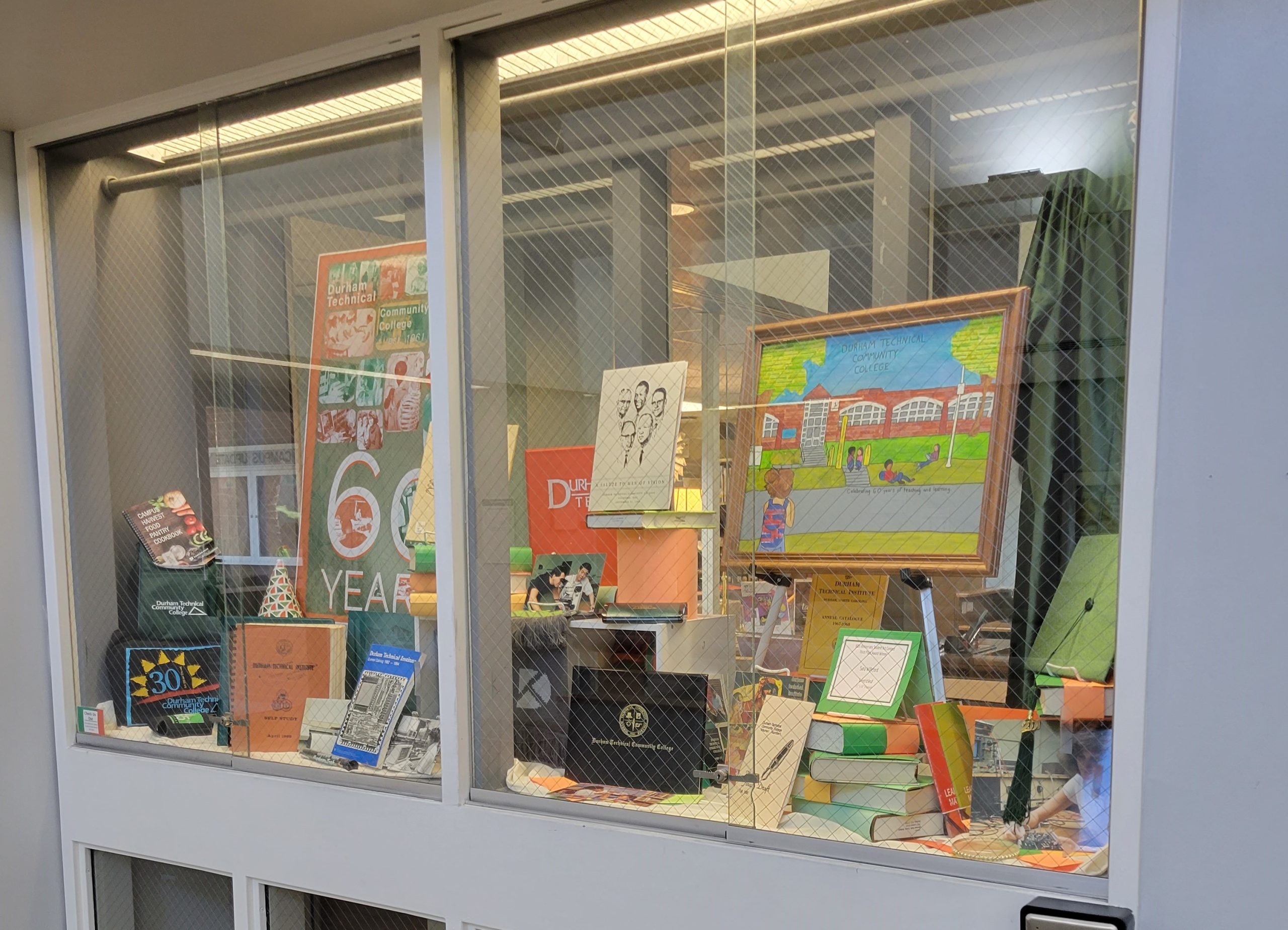 Full window display for the College's 60th Anniversary featuring materials from the Archives.