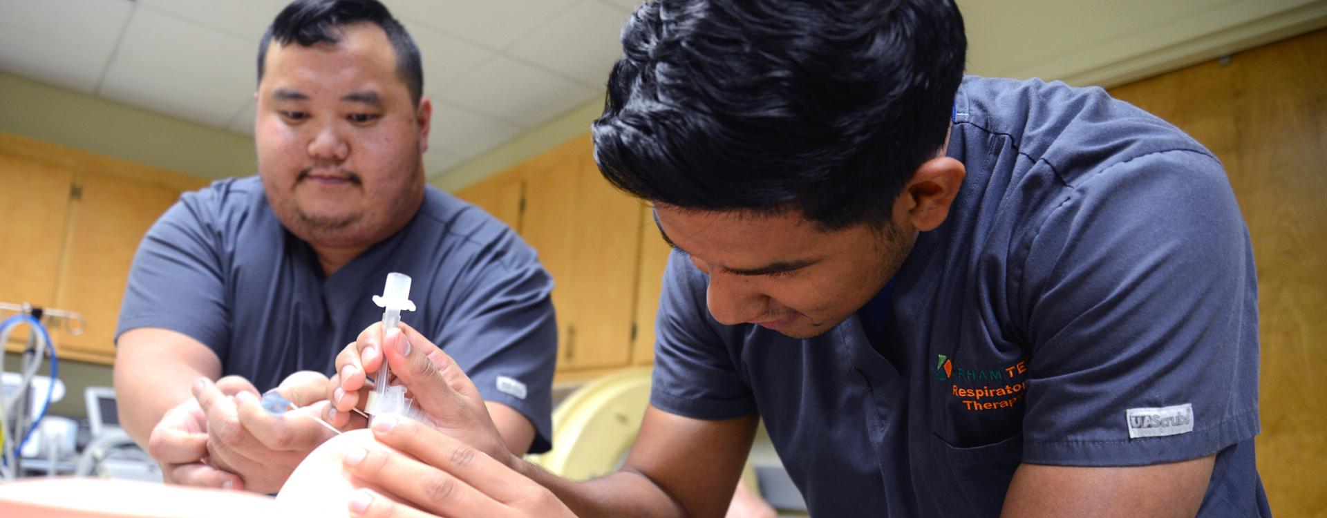 teacher between two students explaining a model in biology