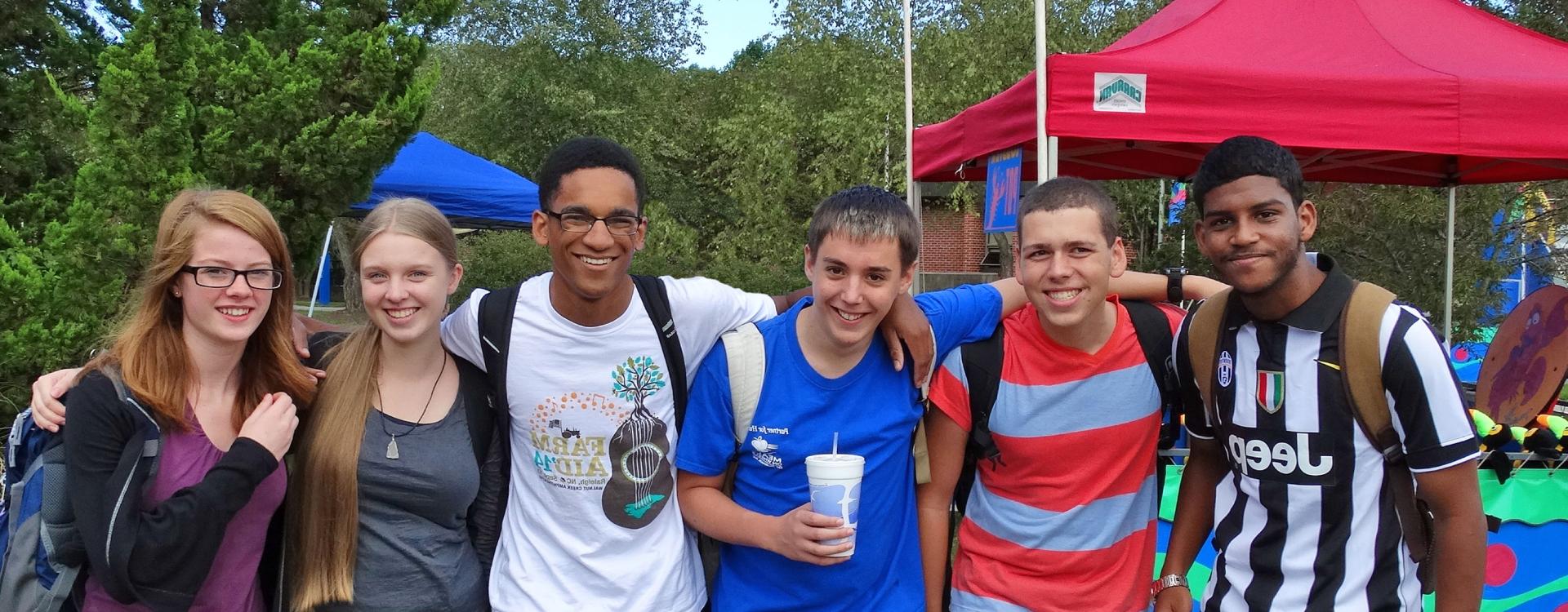 group of students posing with arms around each other's shoulders
