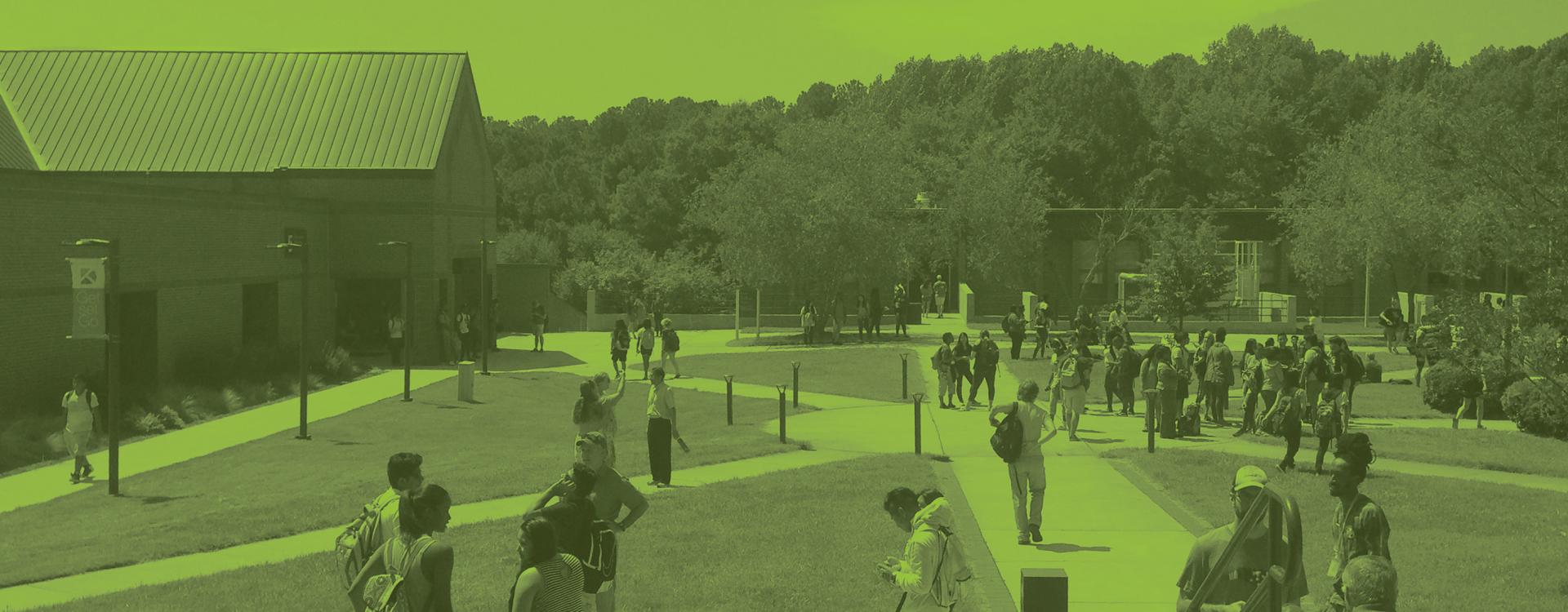 Photo of main campus with several students walking around