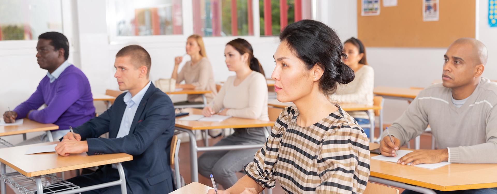 class of employees taking notes at a training class
