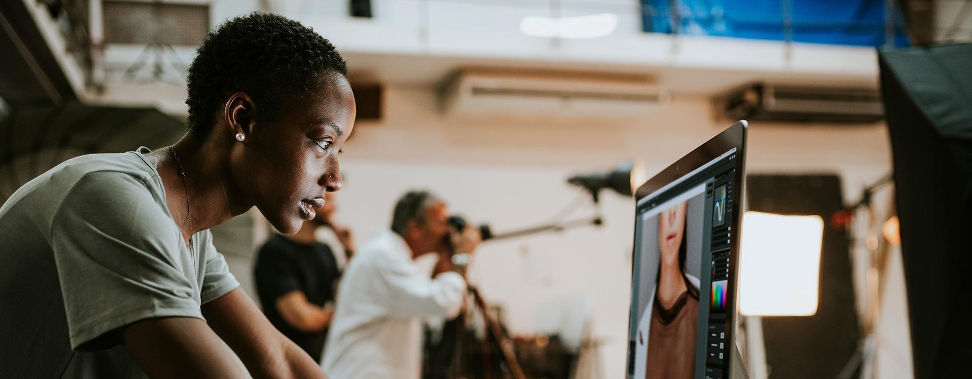 photography student looks at computer screen to assess best images