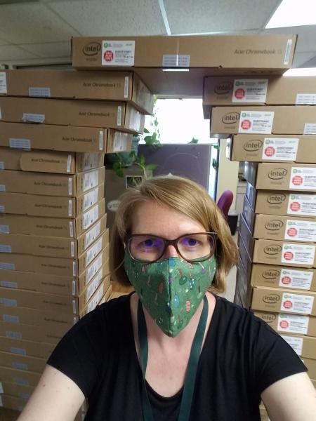 Julie wearing a mask in front of the laptop tower