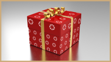 Gift box wrapped with wrapping paper decorated with the Canvas logo. It is tied up with a shiny gold ribbon and bow on top..