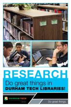 Reference shelves, students studying at laptop computers and using books