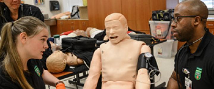 EMS Students around a test dummy