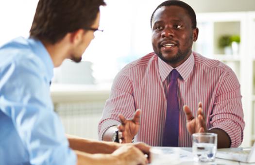 A human resources professional talks to an employee during a meeting.