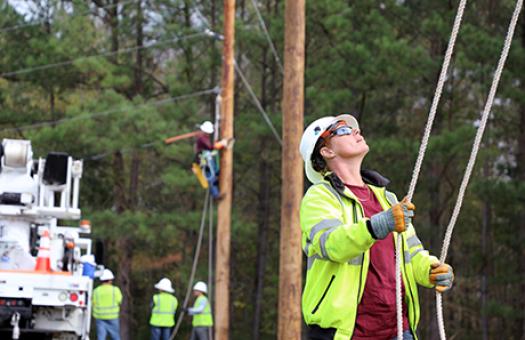 students training on electrical line truck and poles
