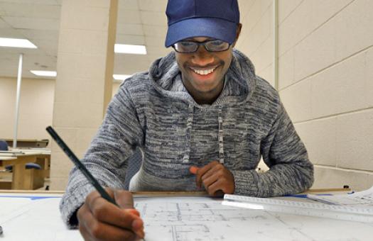 Drafting student works on architectural plans