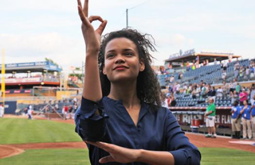 student signs the national anthem at a sporting event