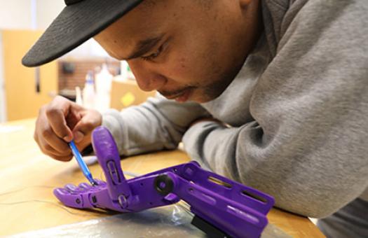 engineering student views connection on artificial hand