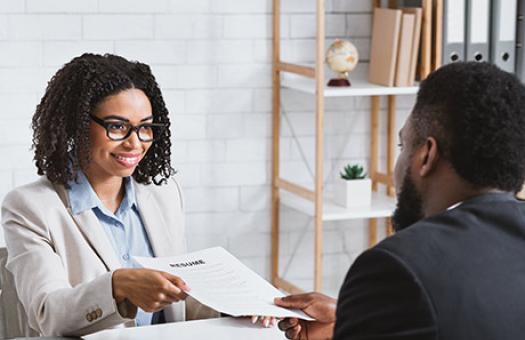 an interviewee presents resume to the human resources manager