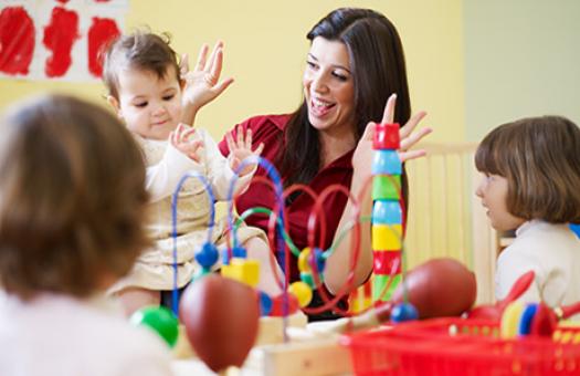 teacher plays games with toddlers