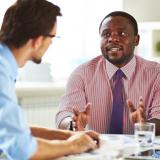 A human resources professional talks to an employee during a meeting.
