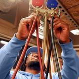 plumbing student adjusting valves and hoses