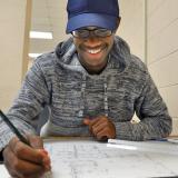 Drafting student works on architectural plans
