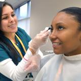 esthetics student applies macara to client in esthetics spa