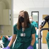 a student watches an EKG monitor while another walks on a treadmill in lab