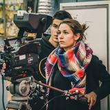 students standing behind a film camera