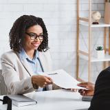 an interviewee presents resume to the human resources manager