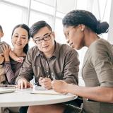 female insurance agent assisting parents with a toddler at a round table