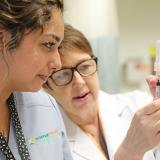 Instructor showing student how to flick a syringe to remove the air bubbles