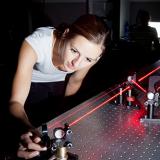 physics student is adjusting a red laser