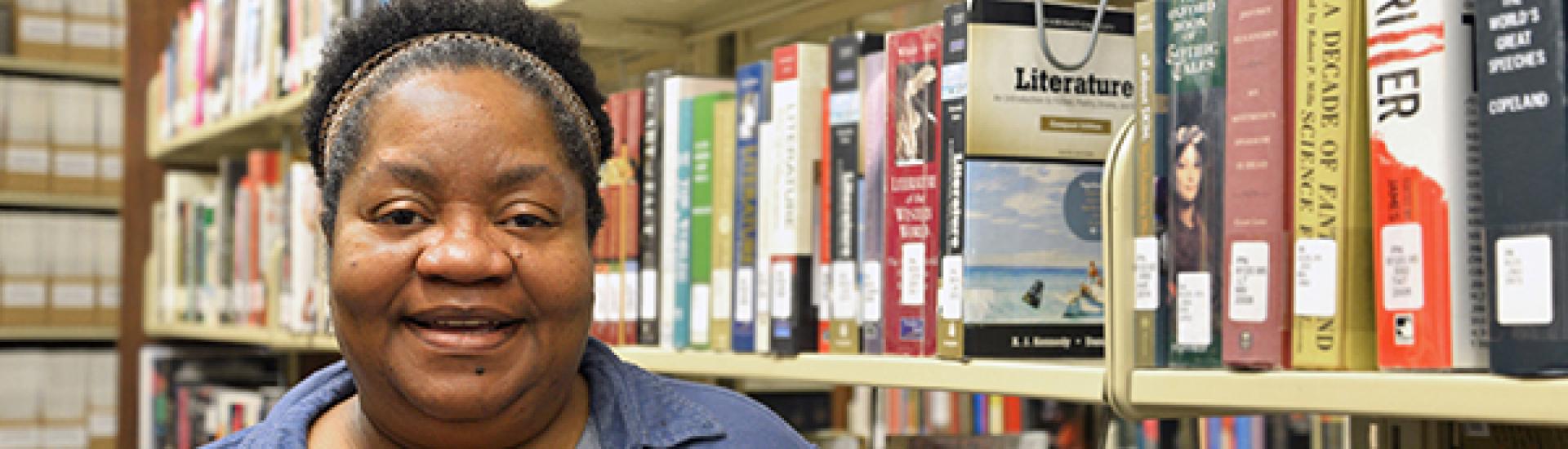 headshot of Theresa Holmes in library