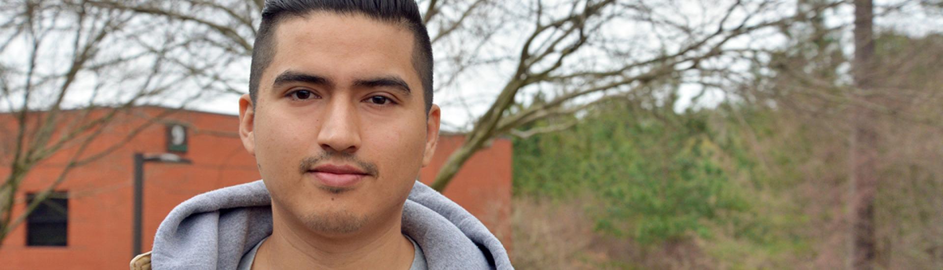 Student standing in front of Health Tech building