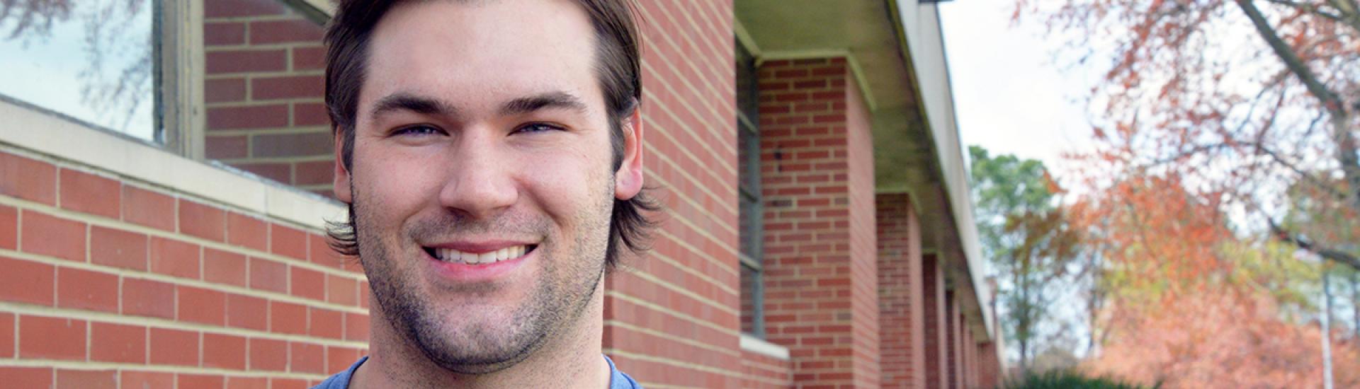 Smiling male Associate Degree Engineering student in t-shirt