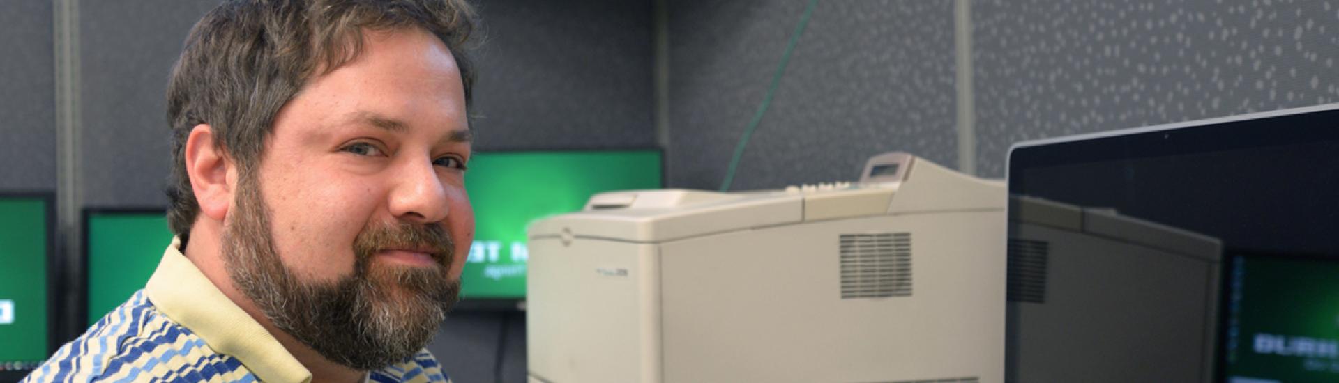 headshot of Beau George in front of computer