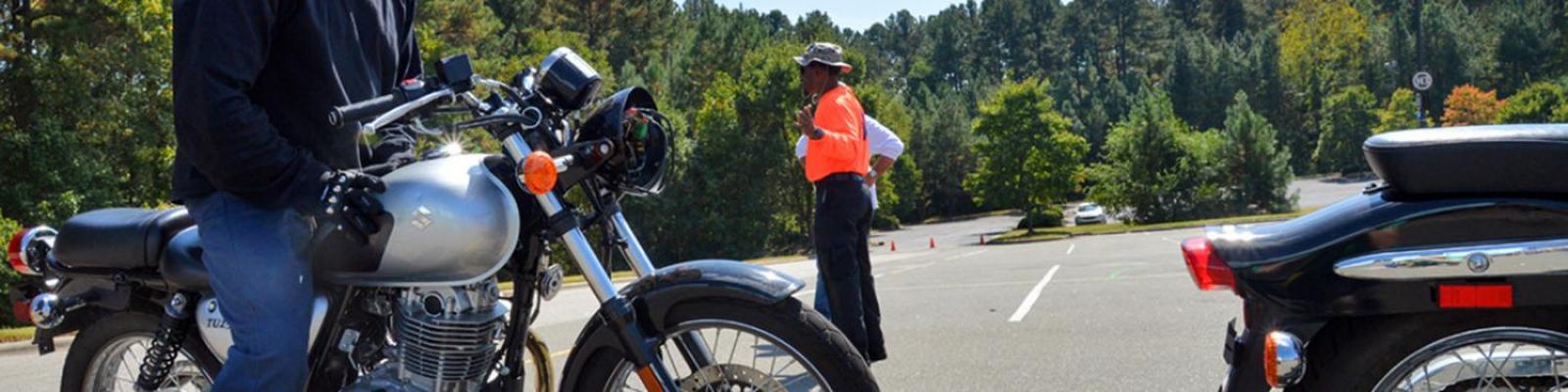 student learning how to drive a motorcycle