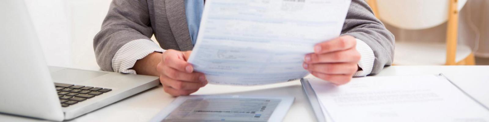 businessman holding a form document