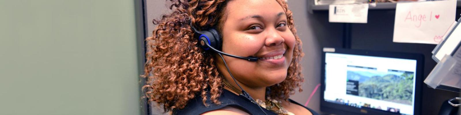 student communication specialist wearing phone headset