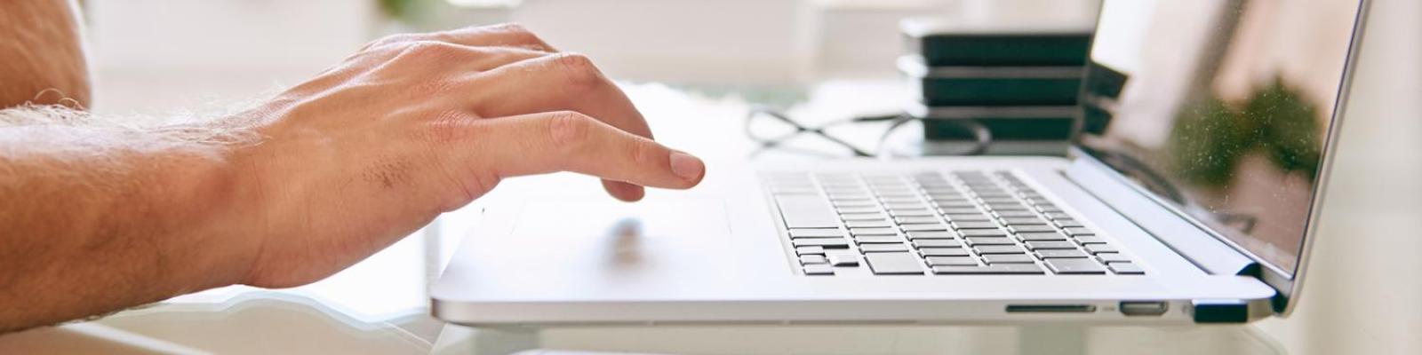 person typing on computer laptop